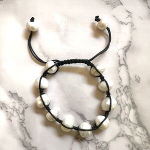 Pearl bracelet on adjustable black silk cord